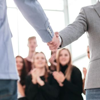 close up. confident young business people meet each other with a handshake.