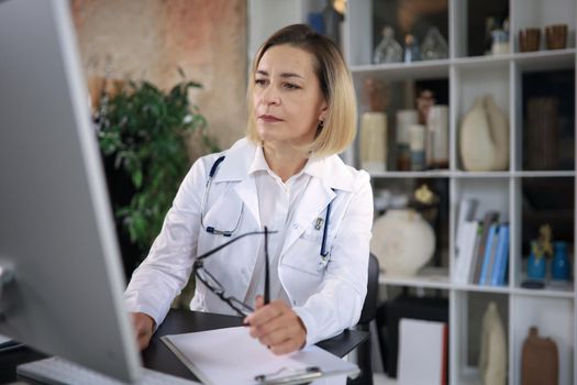 Middle aged female doctor therapist on consultation