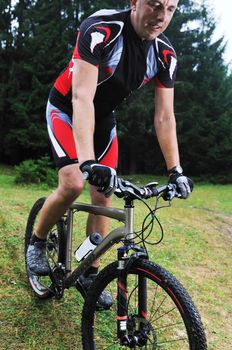 healthy lifestyle and fitness concept with mount bike man who ride bike  outdoor