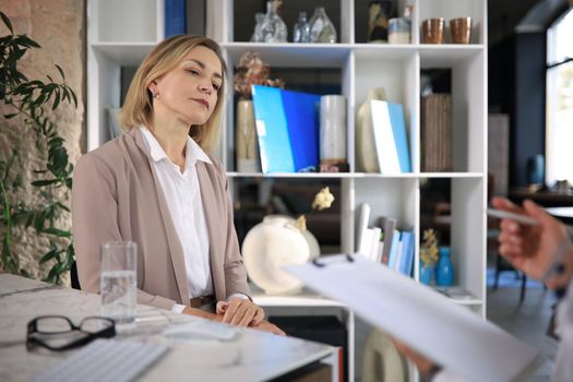 Psychologist listening to her patient and writing down notes. Mental health and counseling concept