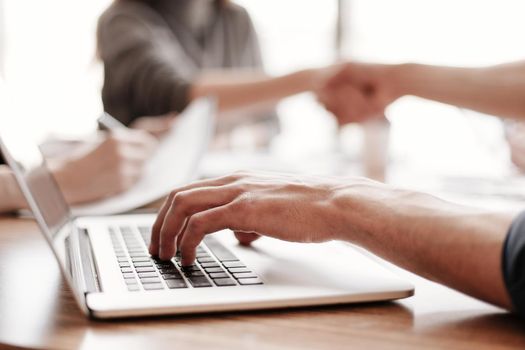 close up. businessman works on a laptop while sitting at an office Desk . business concept .