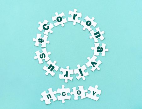 Circle made of white jigsaw puzzle pieces with word coronavirus on blue, top view