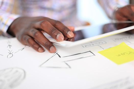 Close-up image of an office worker using a touchpad to analyze statistical data