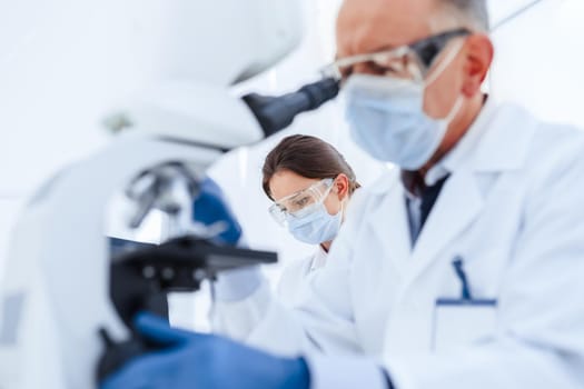 image of a group of scientists working conducting research in a medical laboratory. photo with a copy-space.