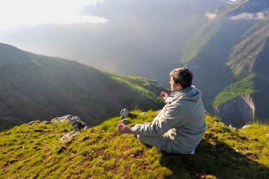 healthy young man practice youga in height mountain at early morning and sunrise