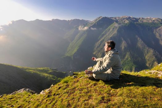 healthy young man practice youga in height mountain at early morning and sunrise