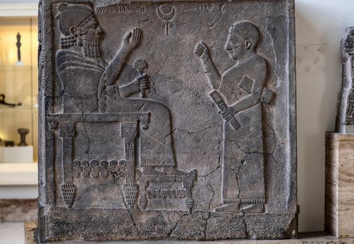 Part of Babylonian bas relief in Berlin Pergamon museum in Germany. Historical ancient art of east religion and civilization. Antique islamic wall decoration