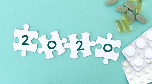 Puzzle pieces in row for lettering next to pills and phonendoscope