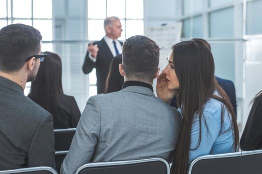 rear view. employees discuss something during a business seminar