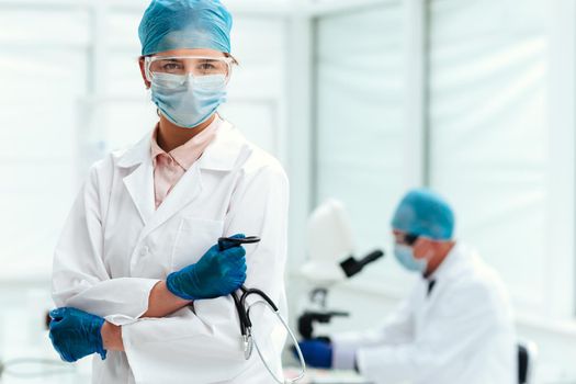 close up. female doctor with a stethoscope standing in the lab. concept of health care.