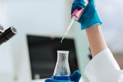 close up. scientist testing a liquid in a laboratory bottle. science and health.