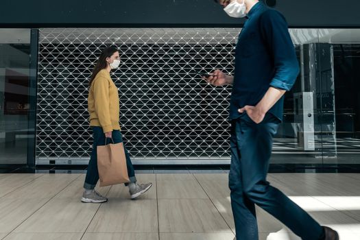 urban residents walking down the street during the pandemic. concept of health protection