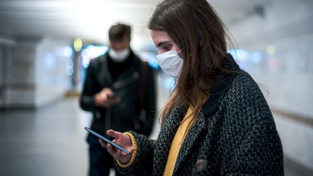 group of residents in protective masks walking in the underpass . coronavirus in the city