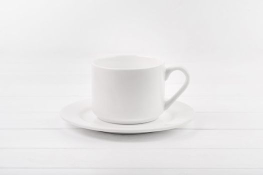 Empty white ceramic plate and cup
