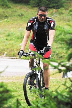 healthy lifestyle and fitness concept with mount bike man who ride bike  outdoor