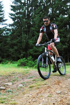 healthy lifestyle and fitness concept with mount bike man who ride bike  outdoor