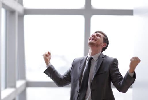 very happy businessman standing in office.photo with copy space.
