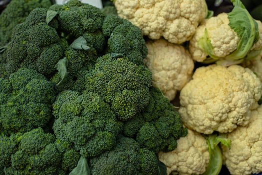 Close up of pile cauliflower and broccoli at the farmers market. Market and trade concept