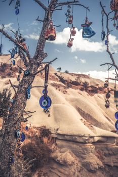 Amulets against evil eye hanging on tree branch