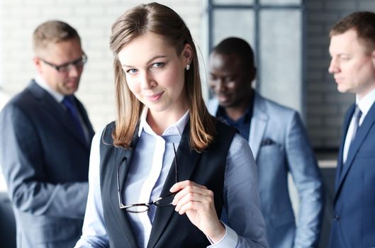 business woman with her staff, people group in background at modern bright office indoors