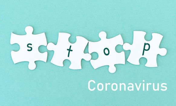Jigsaw puzzle pieces, word STOP coronavirus