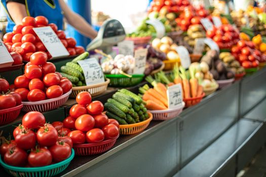 Beautiful picture of red and white tomatoes with a ot of vegetables sold on the market.