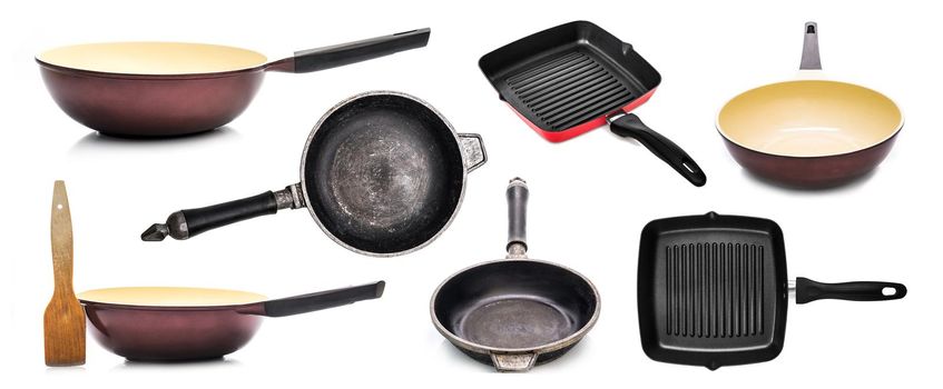 Different frying pans and spatula isolated on white background