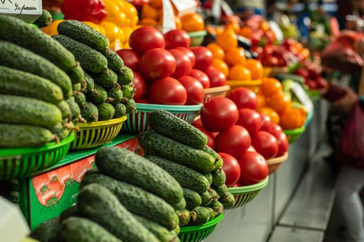 Beautiful picture of green cucumbers with red and white tomatoes sold on the market