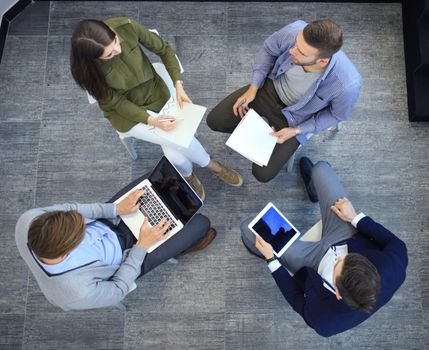Top view of working business group sitting during corporate meeting.