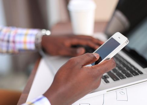 Cropped view of professional male UX web designer working on his new smartphone templates project while using blank screen tablet