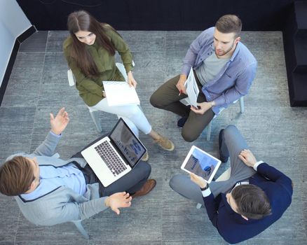 Top view of working business group sitting during corporate meeting.