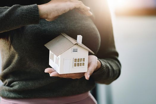 Real estate agent gesturing to protect homes, housing insurance concept