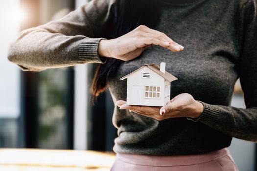 Real estate agent gesturing to protect homes, housing insurance concept