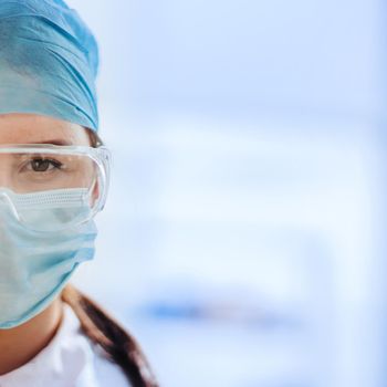 close up. portrait of a female medical scientist in a protective mask.