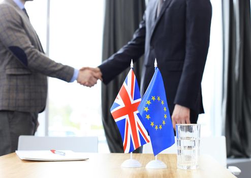 European Union and United Kingdom leaders shaking hands on a deal agreement