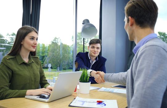 Job applicant having interview. Handshake while job interviewing.