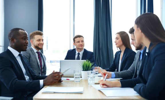 Business team discussing together business plans in office