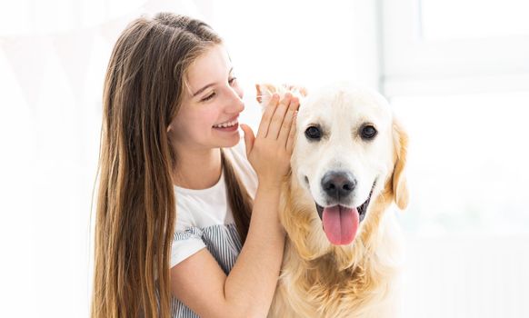 Smiling teenage girl telling secret to cute dog