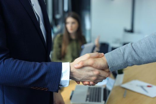 Closeup of a business hand shake between two colleagues