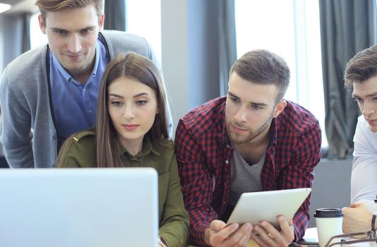 Young group of people doing their jobs on laptop.