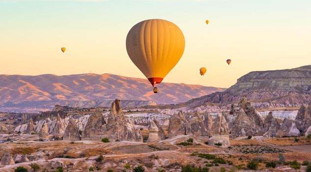 Hot air balloons flying on sunset sky in Cappadocia, Turkey