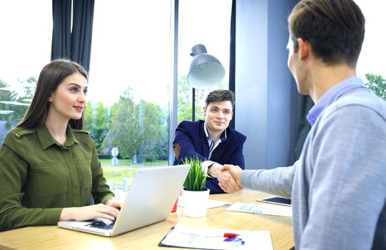 Job applicant having interview. Handshake while job interviewing.