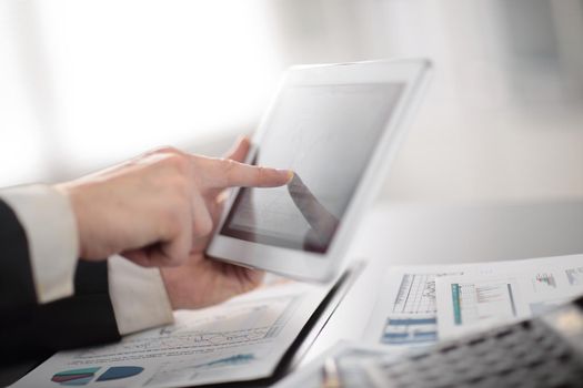 close up.businessman using digital tablet in the workplace.