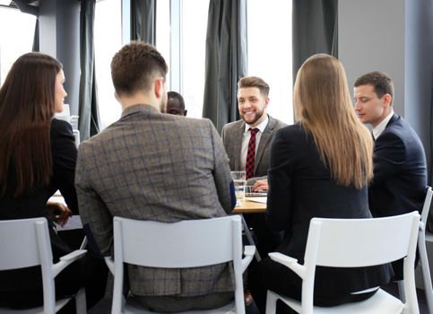 Business team discussing together business plans in office