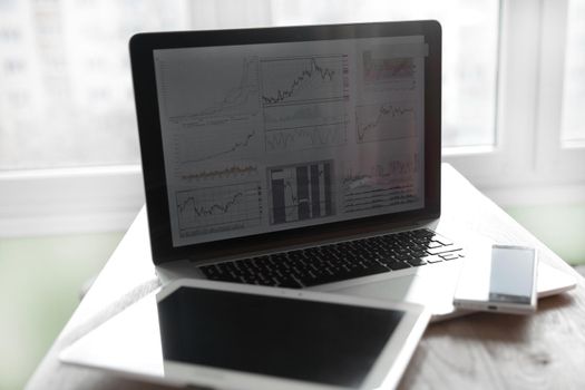 close up.blurred image of notebook and digital tablet in the workplace.