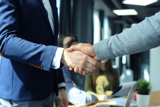 Business people shaking hands, finishing up a meeting