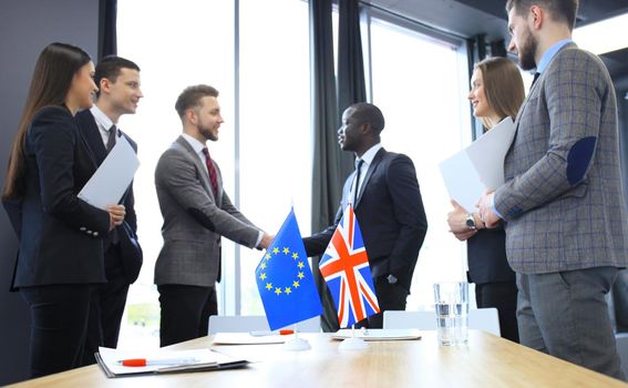 European Union and United Kingdom leaders shaking hands on a deal agreement