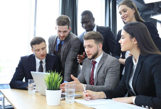 Business team discussing together business plans in office