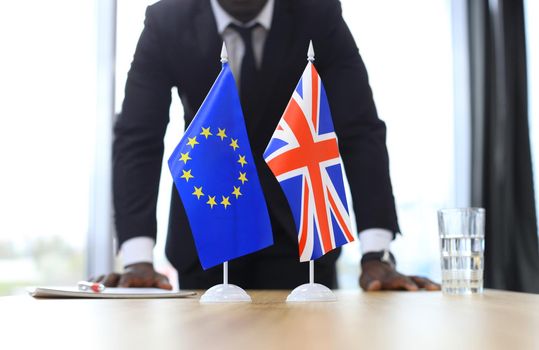 British flag and flag of European Union with businessman near by. Brexit