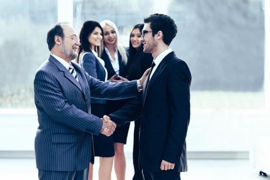 business meeting business partners in office with a handshake